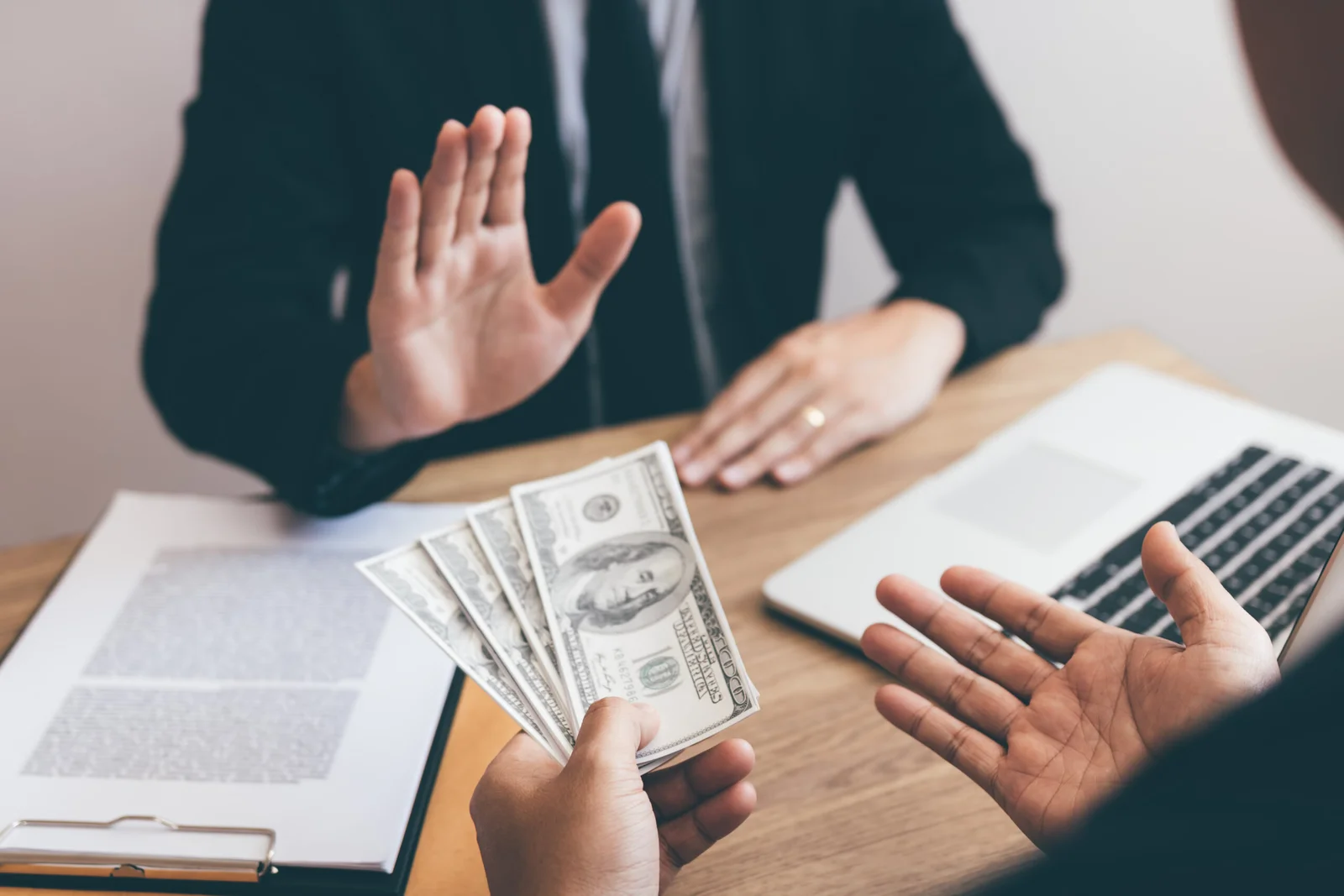 businessperson refusing bribe